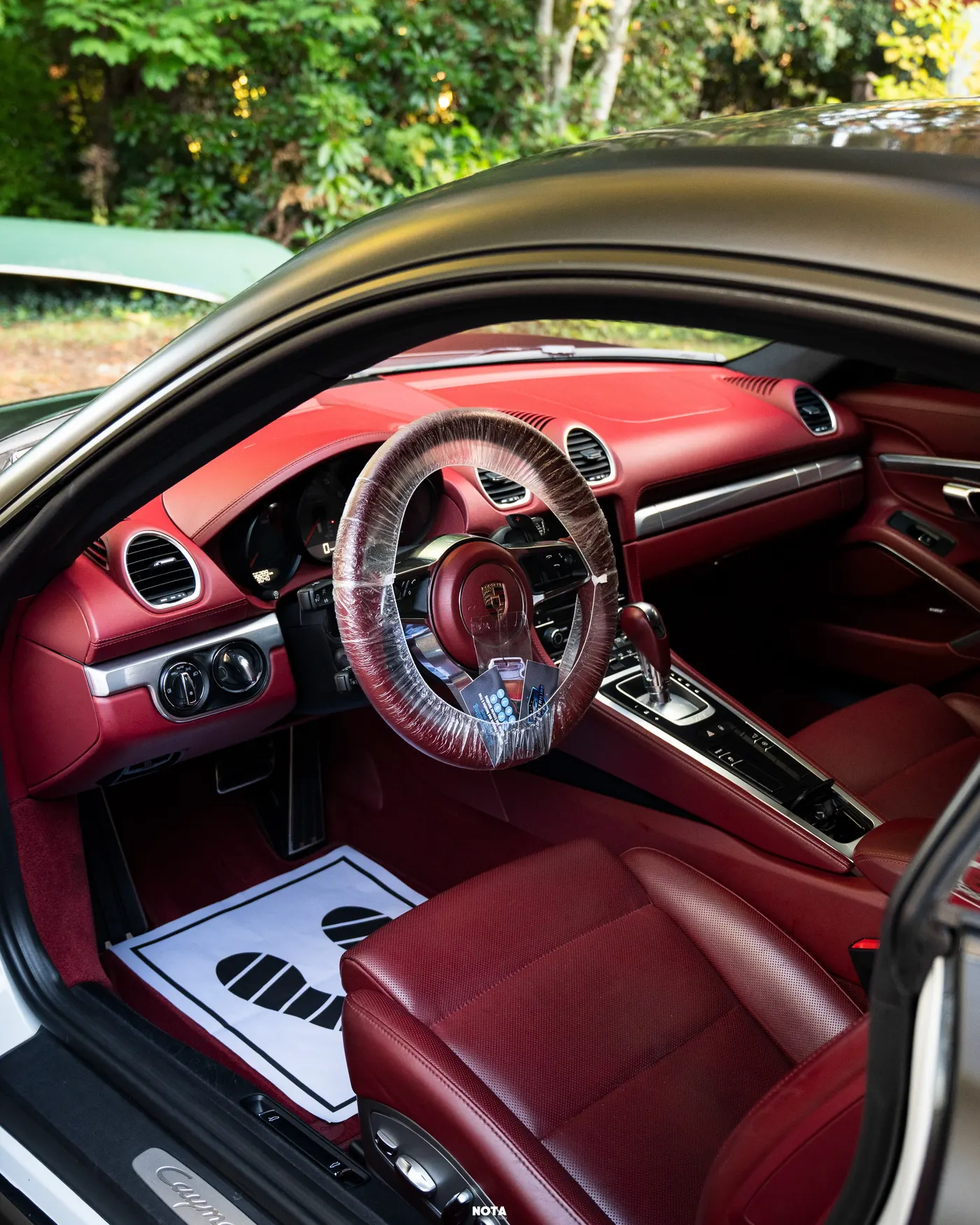 Porsche Cayman interior in red leather after an interior detail by GO's Detailing